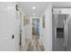 Hallway view showing modern appliances, access to bathroom and bedroom at 7422 New York Ave, Hudson, FL 34667