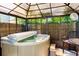 Enclosed gazebo with a hot tub at 7422 New York Ave, Hudson, FL 34667