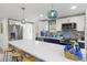 Modern kitchen featuring white cabinets, stainless steel appliances, and an island with bar seating at 7422 New York Ave, Hudson, FL 34667