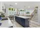 Open concept kitchen with large island, pendant lighting, and seamless transition to living area at 7422 New York Ave, Hudson, FL 34667