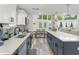 Spacious kitchen with an island bar and stainless steel appliances overlooking the dining and living area at 7422 New York Ave, Hudson, FL 34667