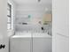 Efficient laundry room with side-by-side washer and dryer for easy chores at 7422 New York Ave, Hudson, FL 34667