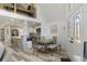 Open-concept living space featuring modern decor, a dining area, and a view of the upper loft at 7422 New York Ave, Hudson, FL 34667