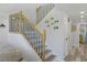 Stairway with wooden railings and decorative fish accents on the wall at 7422 New York Ave, Hudson, FL 34667
