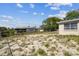 Backyard with a partial view of the house, showing the potential for outdoor space at 7535 Christina Ln, Port Richey, FL 34668