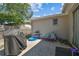 Outdoor patio space featuring a grill, kiddie pool, and seating, ideal for relaxation and leisure at 7535 Christina Ln, Port Richey, FL 34668
