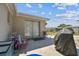 Outdoor patio with a grill, seating, and sliding doors, extending living space for relaxation and enjoyment at 7535 Christina Ln, Port Richey, FL 34668