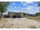 Spacious backyard featuring a grill and potential for landscaping or outdoor activities at 7535 Christina Ln, Port Richey, FL 34668