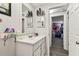 Bathroom featuring a white vanity and sink, and is accessible to the bedroom at 7535 Christina Ln, Port Richey, FL 34668