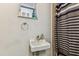 Cozy bathroom with a sink, mirror, and striped shower curtain for a clean and functional space at 7535 Christina Ln, Port Richey, FL 34668