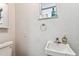 Functional bathroom with a clean white sink and toilet, providing a simple and practical design at 7535 Christina Ln, Port Richey, FL 34668
