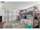 Spacious bedroom with a bunk bed, closet, and ample storage space at 7535 Christina Ln, Port Richey, FL 34668