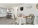 Cozy dining room featuring a round table set for four, with seamless flow to the living area at 7535 Christina Ln, Port Richey, FL 34668