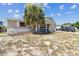 Charming single-story home with a covered front porch and drought resistant landscaping at 7535 Christina Ln, Port Richey, FL 34668