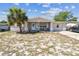 Charming single-story home featuring a covered front porch and a spacious front yard at 7535 Christina Ln, Port Richey, FL 34668