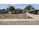 This single-story house features a welcoming covered front porch and a convenient driveway for easy access at 7535 Christina Ln, Port Richey, FL 34668