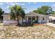 A well-kept one-story home with a covered porch, a tidy front yard, and a welcoming facade at 7535 Christina Ln, Port Richey, FL 34668