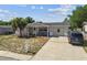 This inviting one-story home boasts a covered porch and driveway in a tidy, welcoming setting at 7535 Christina Ln, Port Richey, FL 34668