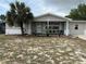 Charming single story home with front porch, neutral paint, and a beautiful palm tree at 7535 Christina Ln, Port Richey, FL 34668