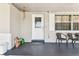 Welcoming front porch with a decorative door, seating, and a glimpse of the home's cozy exterior at 7535 Christina Ln, Port Richey, FL 34668