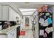 Galley kitchen with granite countertops, white cabinets, and black appliances at 7535 Christina Ln, Port Richey, FL 34668