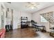 Adaptable room featuring wood-look floors and a ceiling fan, complemented by ample natural light at 7535 Christina Ln, Port Richey, FL 34668
