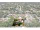 Scenic aerial view highlighting a home surrounded by mature trees, featuring a green lawn and spacious driveway at 7630 Landmark Dr, Spring Hill, FL 34606