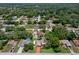 Overhead view of a serene neighborhood with mature trees and well-maintained lawns, showcasing a variety of home styles at 7630 Landmark Dr, Spring Hill, FL 34606