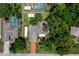 An aerial view shows the home, surrounding lawn with mature trees, plus a driveway and RV parking at 7630 Landmark Dr, Spring Hill, FL 34606