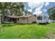 The home's backyard features a screened in porch, a mature tree, and dedicated RV parking at 7630 Landmark Dr, Spring Hill, FL 34606