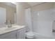 Bright bathroom featuring a vanity, toilet, and a shower-tub combination with white tile at 7630 Landmark Dr, Spring Hill, FL 34606