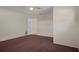 Bedroom features neutral walls, carpet, and open doorway leading to adjoining room at 7630 Landmark Dr, Spring Hill, FL 34606