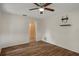 This bedroom features updated flooring, a ceiling fan, and a mounted tv stand at 7630 Landmark Dr, Spring Hill, FL 34606