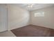 Bedroom with neutral decor, ceiling fan, bright window, and carpeted flooring at 7630 Landmark Dr, Spring Hill, FL 34606