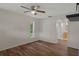 Bright bedroom with ceiling fan, wood floors, and ensuite bathroom at 7630 Landmark Dr, Spring Hill, FL 34606
