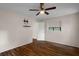 This bedroom features updated flooring, a ceiling fan, and a mounted tv stand at 7630 Landmark Dr, Spring Hill, FL 34606