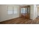 Formal dining room with wood floors, chandelier, and classic china cabinet at 7630 Landmark Dr, Spring Hill, FL 34606
