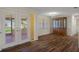 Bright dining room featuring wood floors, stylish chandelier, and sliding glass doors to outdoor space at 7630 Landmark Dr, Spring Hill, FL 34606