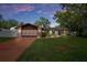 Charming single story home with a well-manicured lawn and a driveway that leads to a spacious two-car garage at 7630 Landmark Dr, Spring Hill, FL 34606