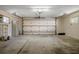 Clean, empty garage featuring a large white door, concrete flooring, and ample space for parking and storage at 7630 Landmark Dr, Spring Hill, FL 34606
