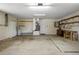 Bright and spacious garage with ample shelving, a work bench, and clean concrete flooring, perfect for projects at 7630 Landmark Dr, Spring Hill, FL 34606