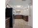 Updated kitchen with stainless steel appliances, breakfast bar, and modern lighting at 7630 Landmark Dr, Spring Hill, FL 34606