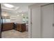 Well-appointed kitchen featuring a breakfast bar, skylight, and modern pendant lights at 7630 Landmark Dr, Spring Hill, FL 34606