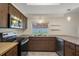 Well-lit kitchen featuring stainless steel appliances, wood cabinets, and granite countertops at 7630 Landmark Dr, Spring Hill, FL 34606