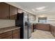 Kitchen featuring stainless steel appliances, wood cabinets, and tile flooring at 7630 Landmark Dr, Spring Hill, FL 34606