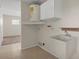 The laundry room has tiled flooring, a utility sink, and a hot water heater at 7630 Landmark Dr, Spring Hill, FL 34606