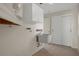 A clean laundry room with overhead cabinets and tiled flooring at 7630 Landmark Dr, Spring Hill, FL 34606