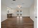 Spacious living room featuring hardwood floors, ceiling fan, and sliding glass doors to the yard at 7630 Landmark Dr, Spring Hill, FL 34606