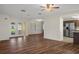 Open living room features durable wood floors, recessed lighting, and flows seamlessly into the adjacent kitchen at 7630 Landmark Dr, Spring Hill, FL 34606