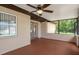 Spacious screened in porch with ceiling fan, with an open view of the backyard at 7630 Landmark Dr, Spring Hill, FL 34606